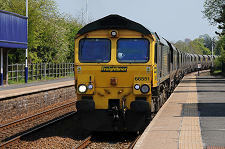 Freight Train Passing Through Station