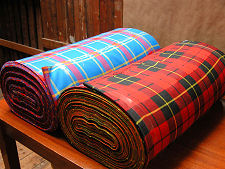 Story of a Tartan. The tartan on the left is the South Australian Pipes & Drums Tartan. Here it is after weaving at Andrew Elliot Ltd in Selkirk